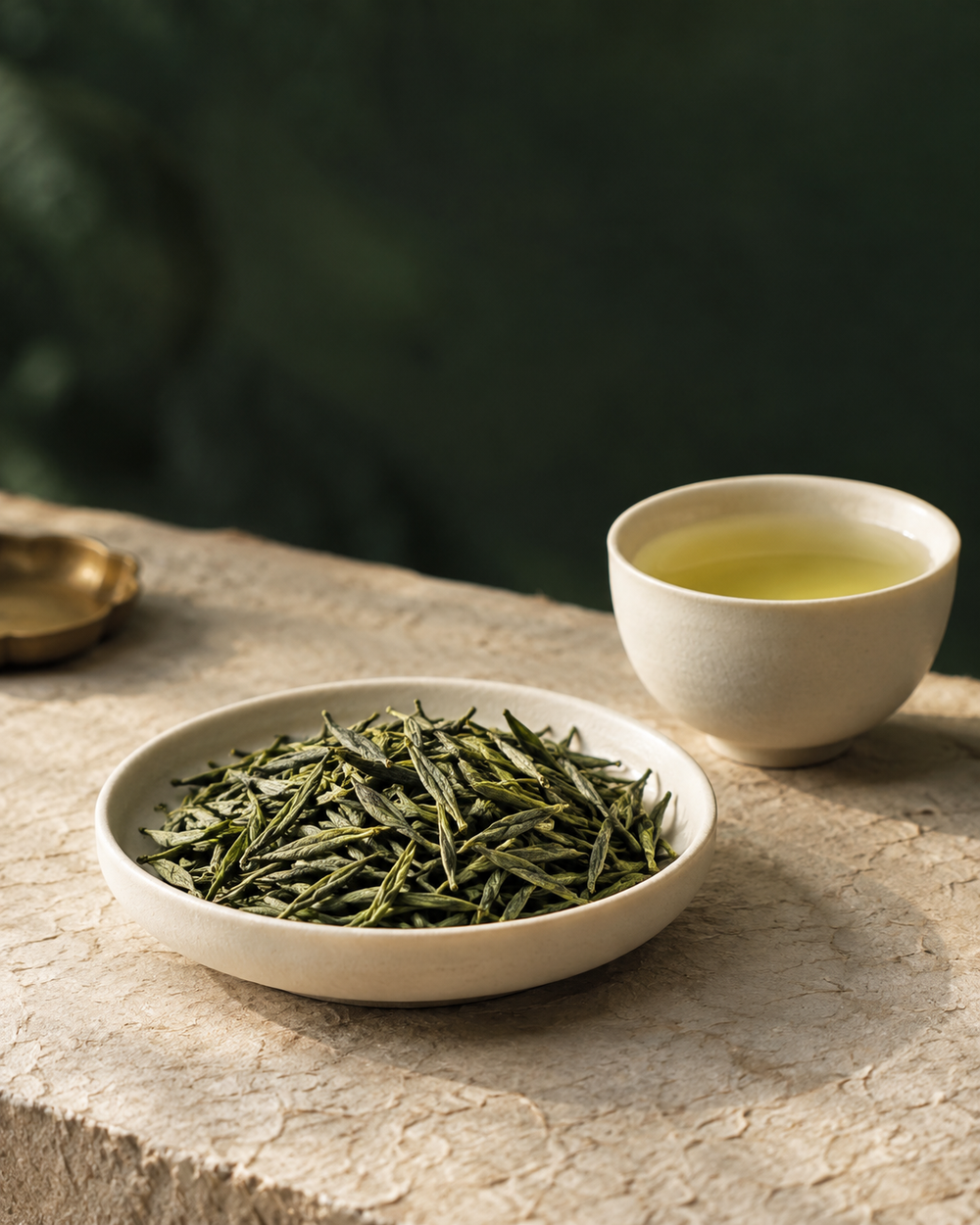 AI-created tea culture illustration of green tea leaves in an ivory dish beside a cup of pale green tea.